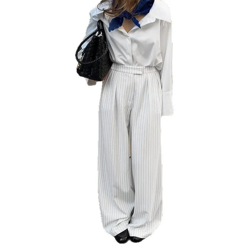 White striped wide-leg trousers with front zipper detail and loose casual fit