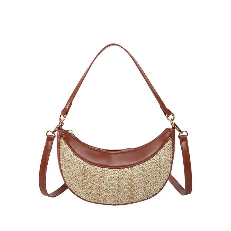 Hard woven straw dumpling-shaped crossbody bag in green with contrast stitching and a single shoulder strap.