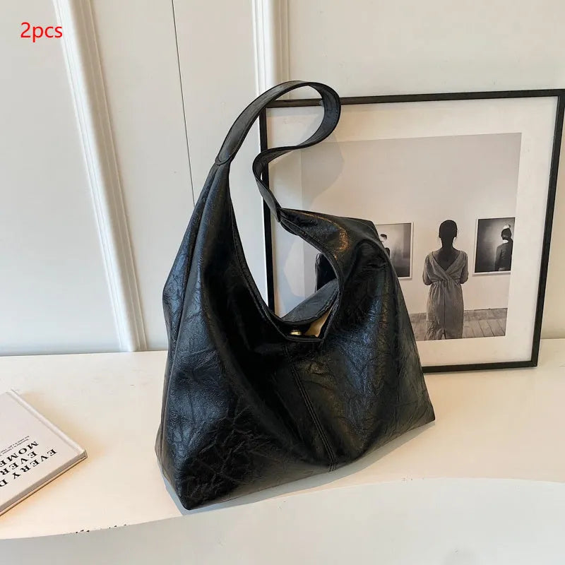 Casual soft PU leather large capacity shoulder bag in street trend style.