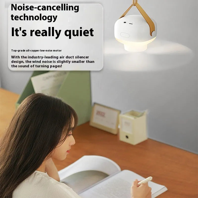 Small white rechargeable ceiling fan with remote control and strap for camping.