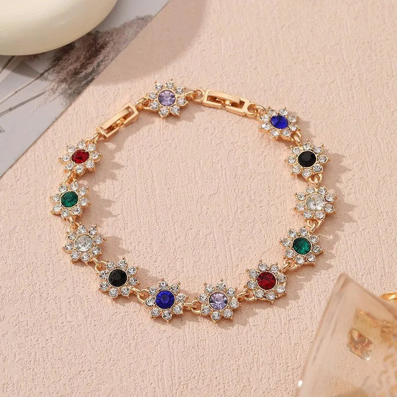 Electroplated zinc alloy bracelet with floral design in gold and silver colour variations