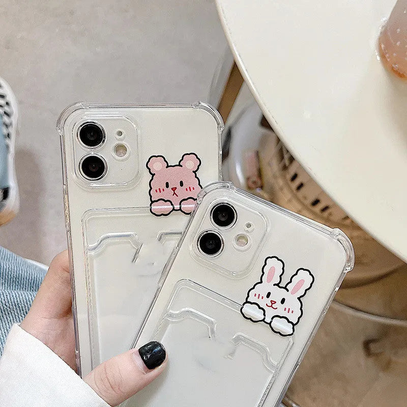 Transparent cartoon-themed iPhone case with a card slot, shown on an iPhone.