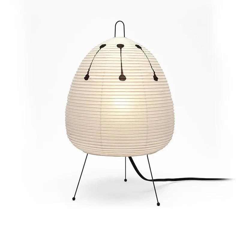 Japanese style rice paper table lamp with aluminium body and decorative shade on wooden surface