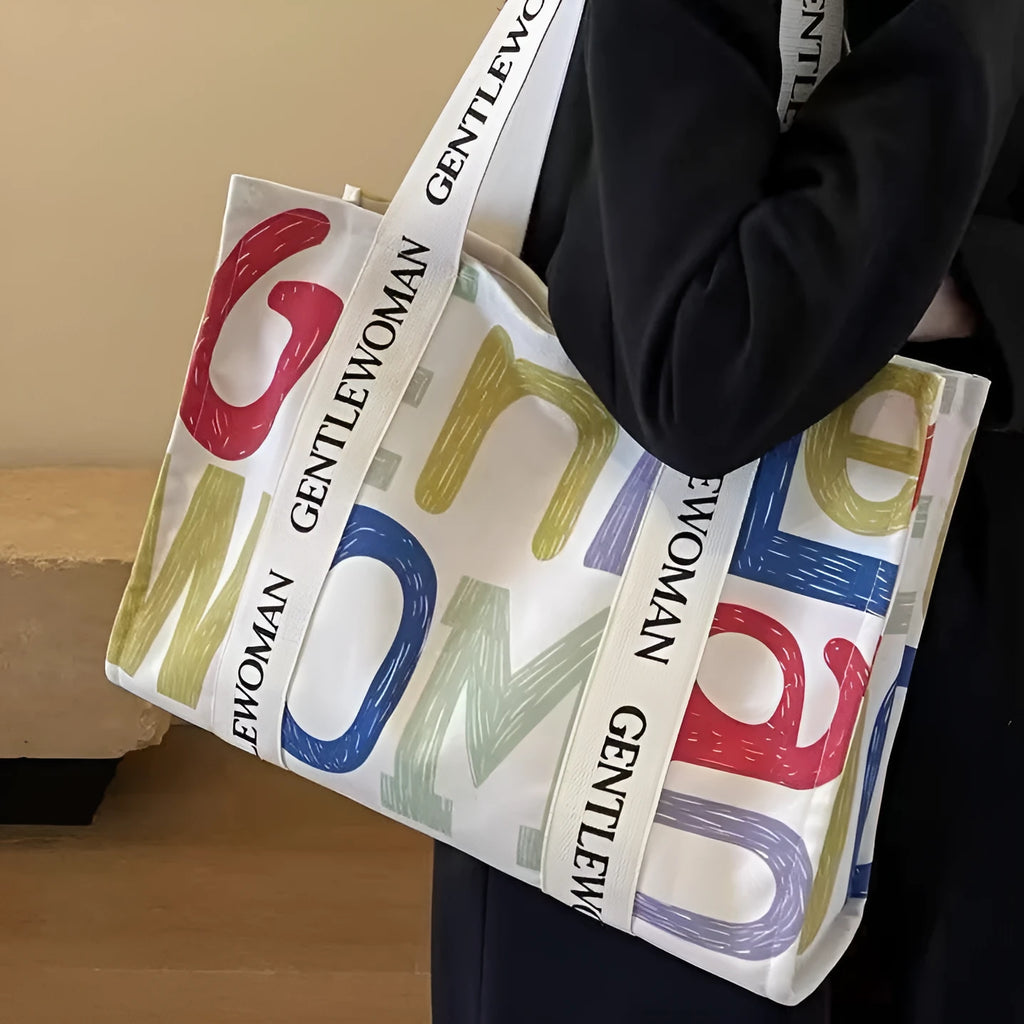 Women's large canvas tote bag with printed design options for travel and shopping.