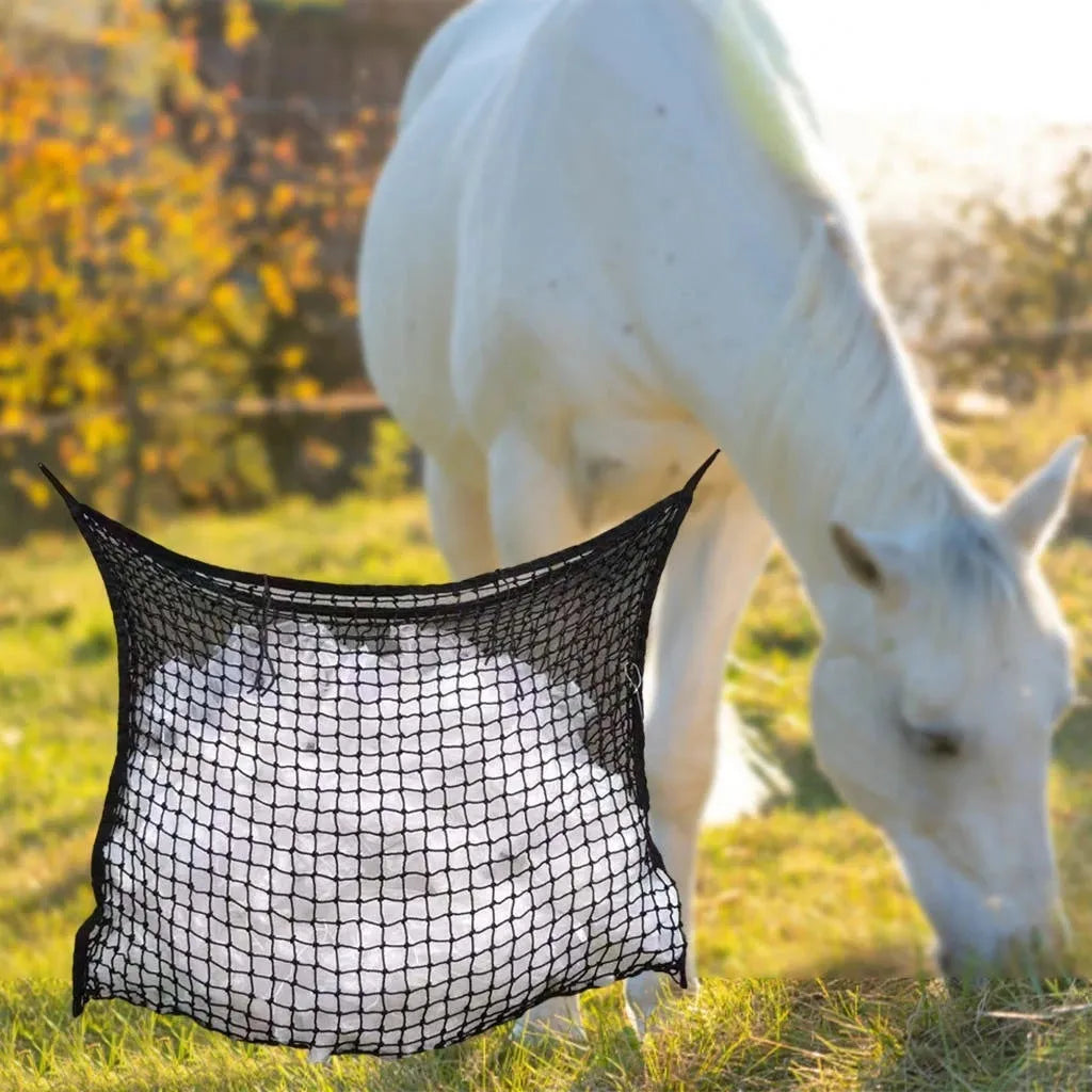 Woven PE rope mesh horse feeding bag hanging with hay inside, black colour shown