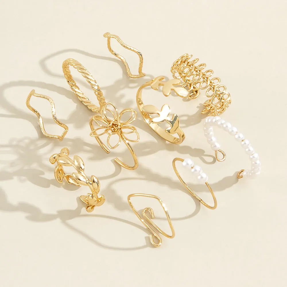 Gold openwork flower ring set showing floral design and glossy electroplated finish