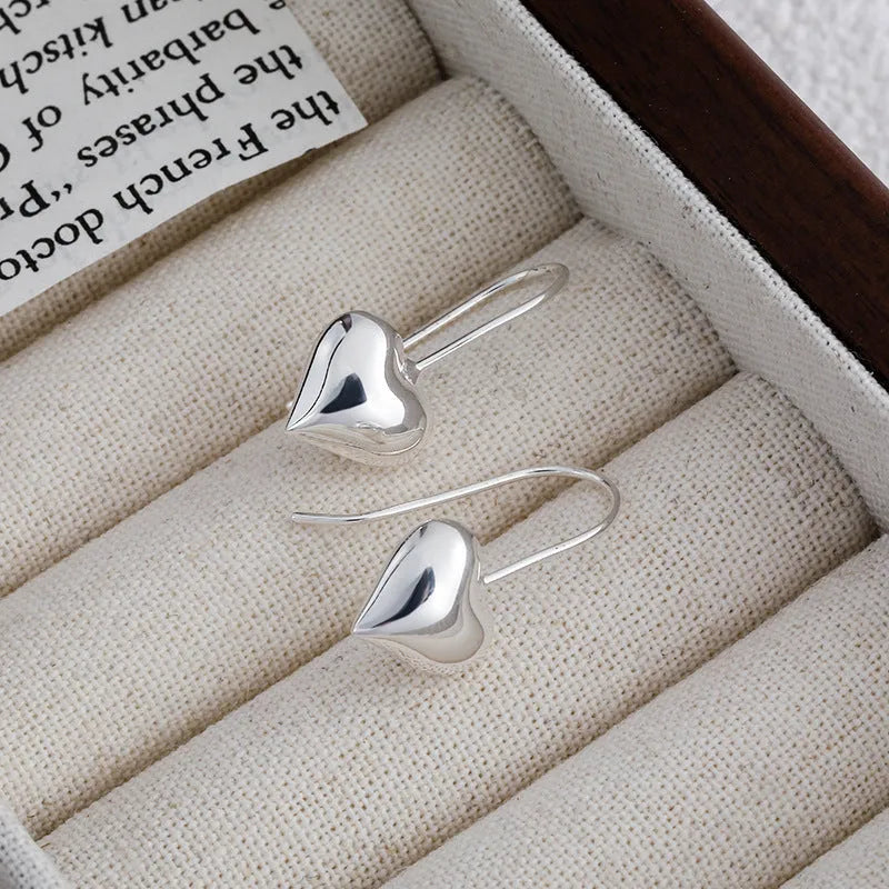 Three-dimensional glossy heart-shaped earrings with white gold colour finish and Korean-style design