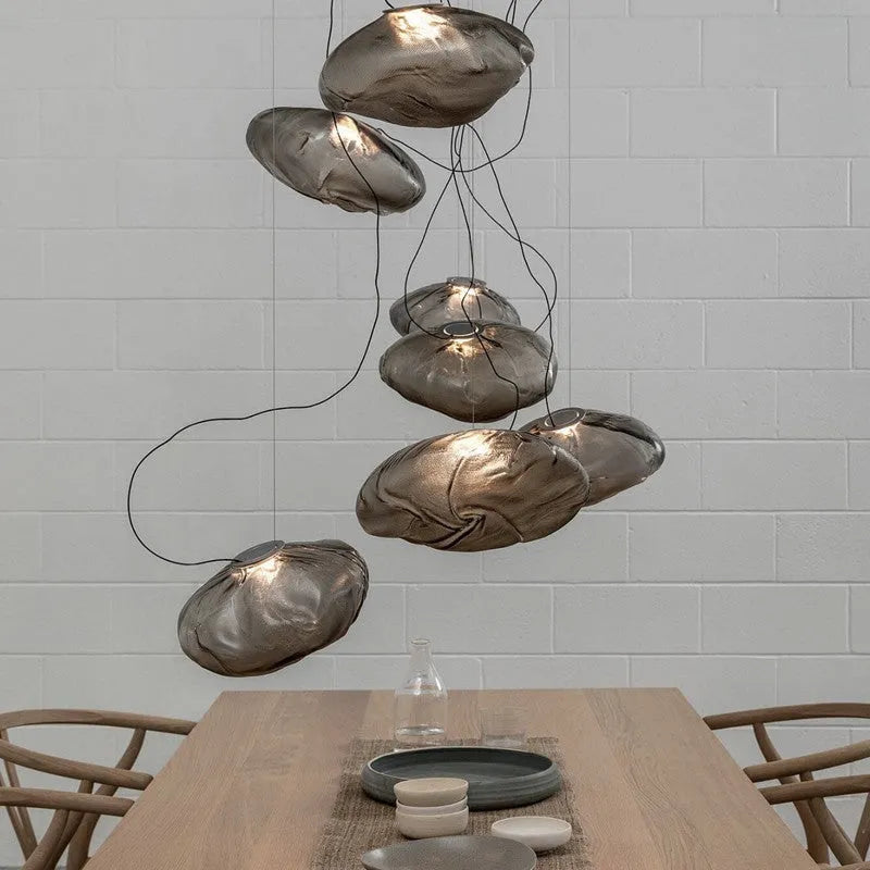 Modern fabric chandelier with glass shade shown in small and large sizes with clear, amber, and smoke grey light options.