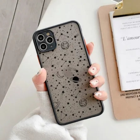 Black anti-blue-light soft-touch iPhone case for multiple models on a table.