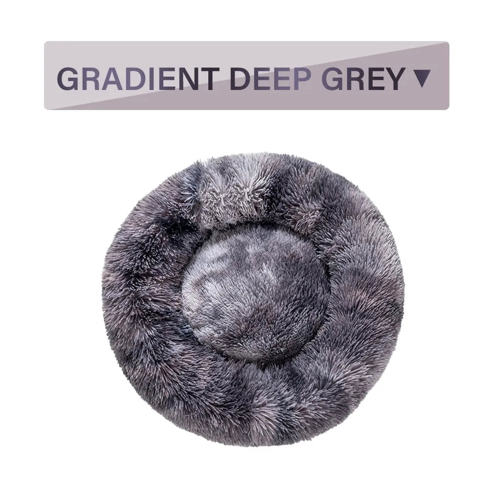 Fluffy donut-shaped pet bed in long plush fabric, shown in a light grey colour.