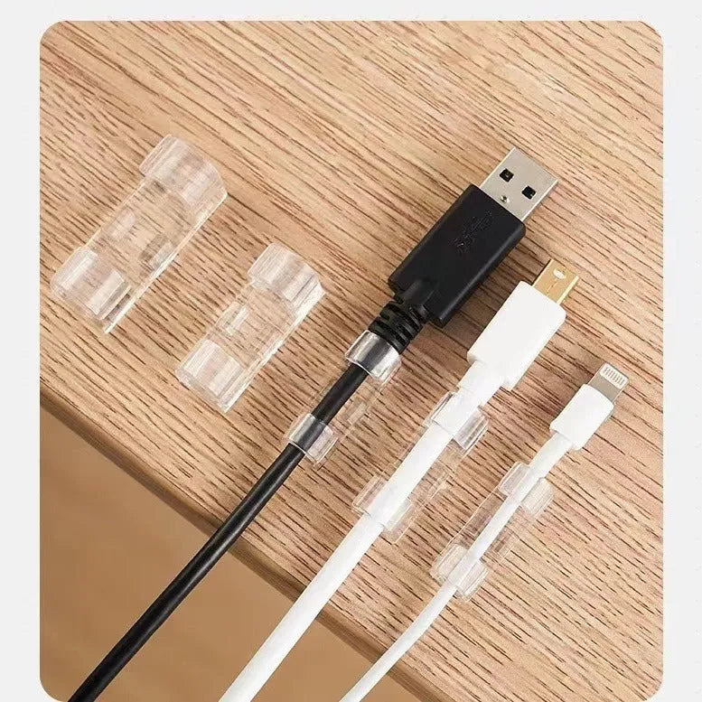 Transparent self-adhesive plastic snap clips for cable management on a white background.
