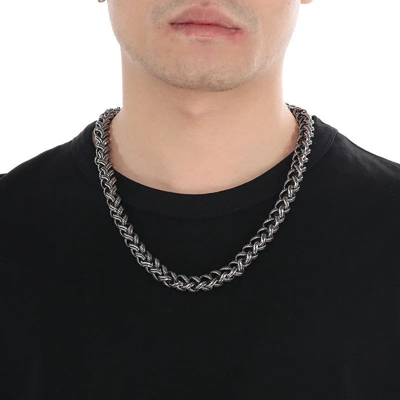 Men's antique silver titanium steel keel chain necklace with large hemp flower links on a grey background.