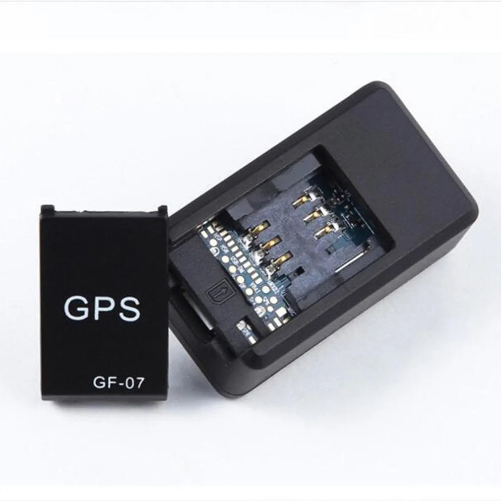 Black plastic magnetic GPS car tracker device measuring 35x20x14mm with USB charging cable