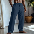 Straight-leg cotton and linen casual trousers in light green colour with visible pockets.