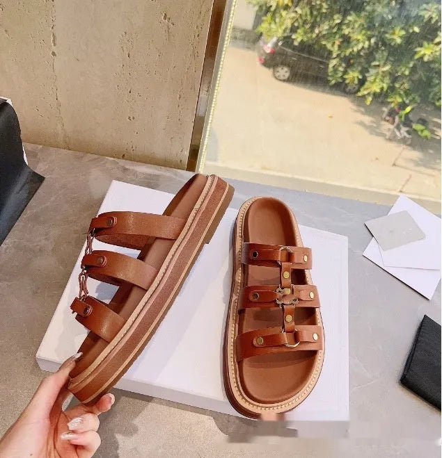 Women's brown patent leather Roman sandal slippers with sheepskin upper on a white background.