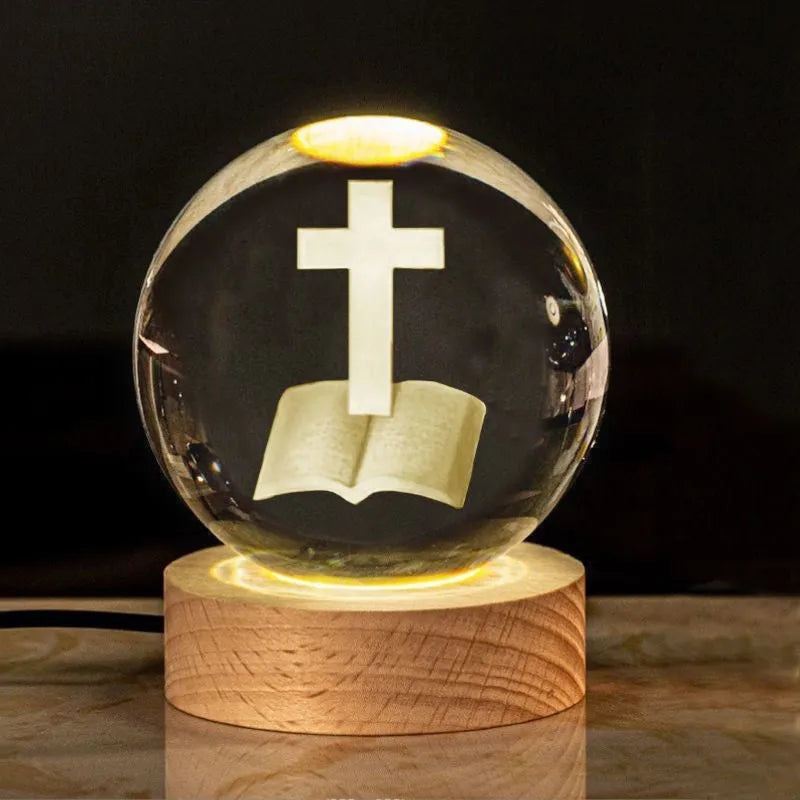 White crystal ball with cross and religious symbols on wooden LED base desk ornament