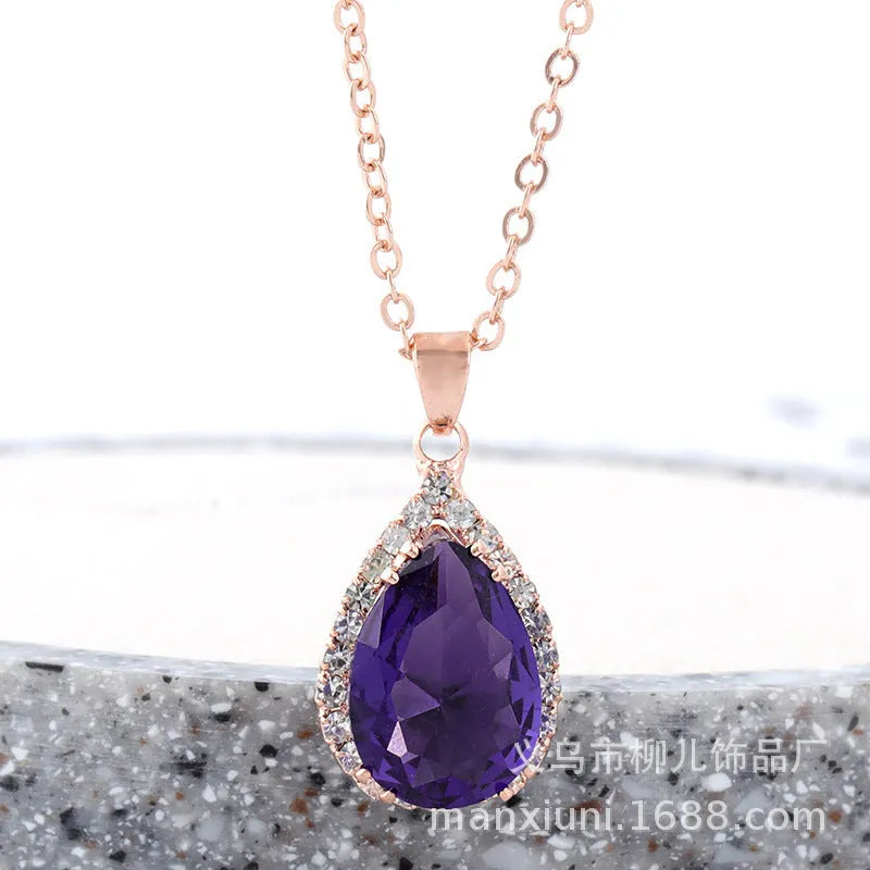 Pink water drop shaped rhinestone necklace with rose gold electroplated alloy pendant on white background