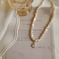 French Court vintage style alloy necklace with geometric pearl pendant on an adjustable chain.