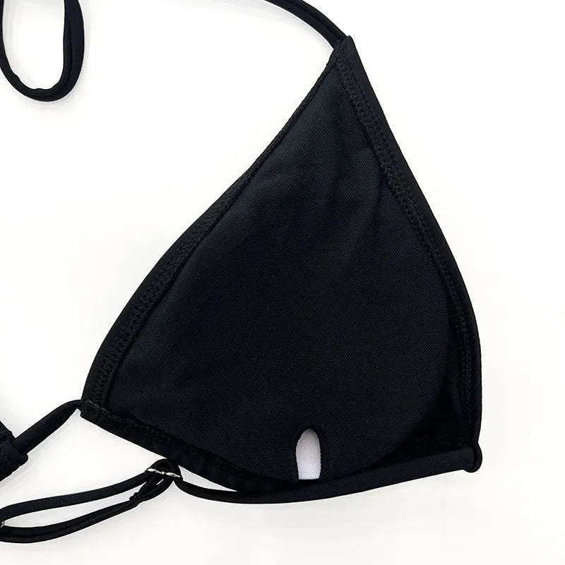 Black mesh women's four-piece bikini set with long sleeve top on a mannequin