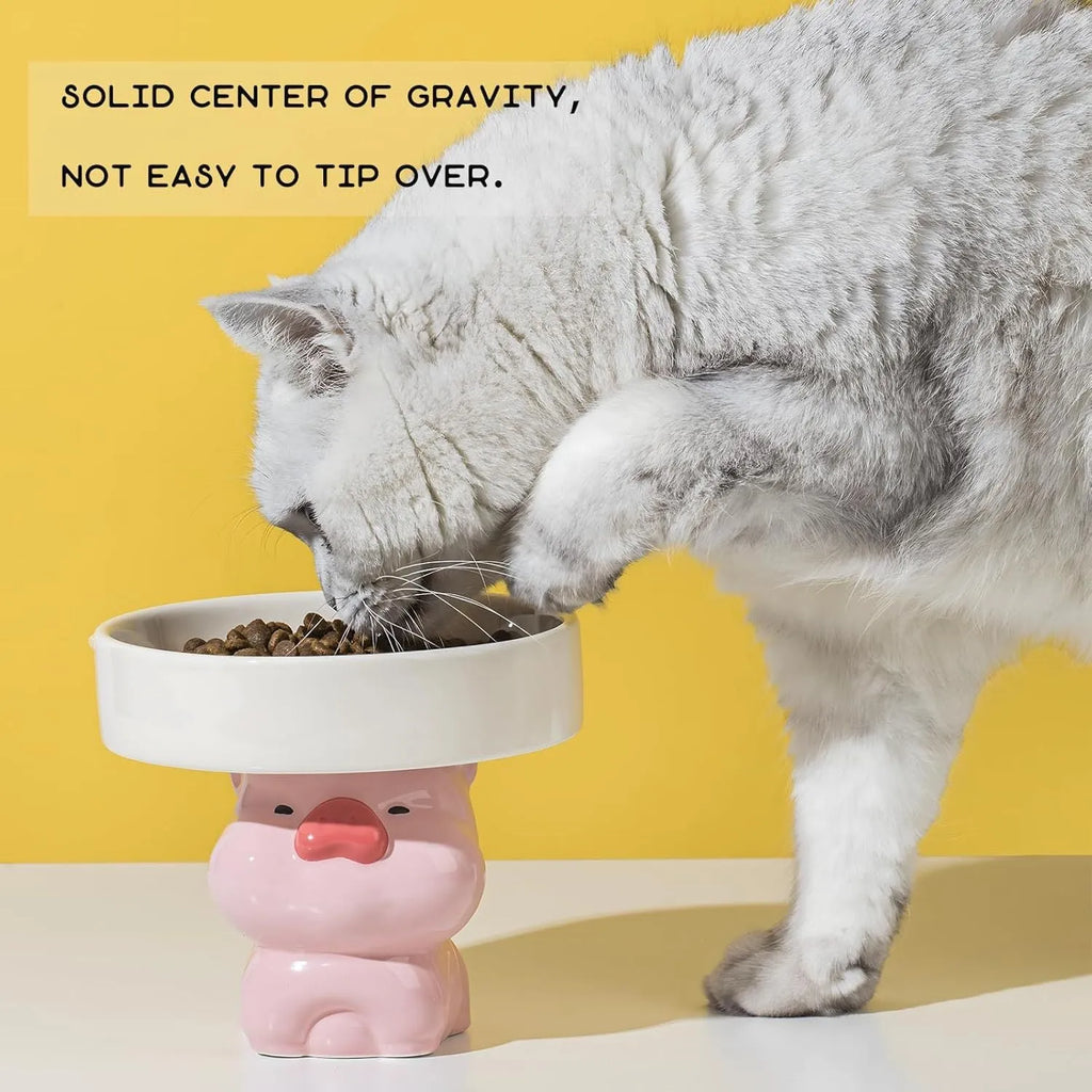 Raised ceramic cat food bowl in animal design, showing elevated height and wide bowl.