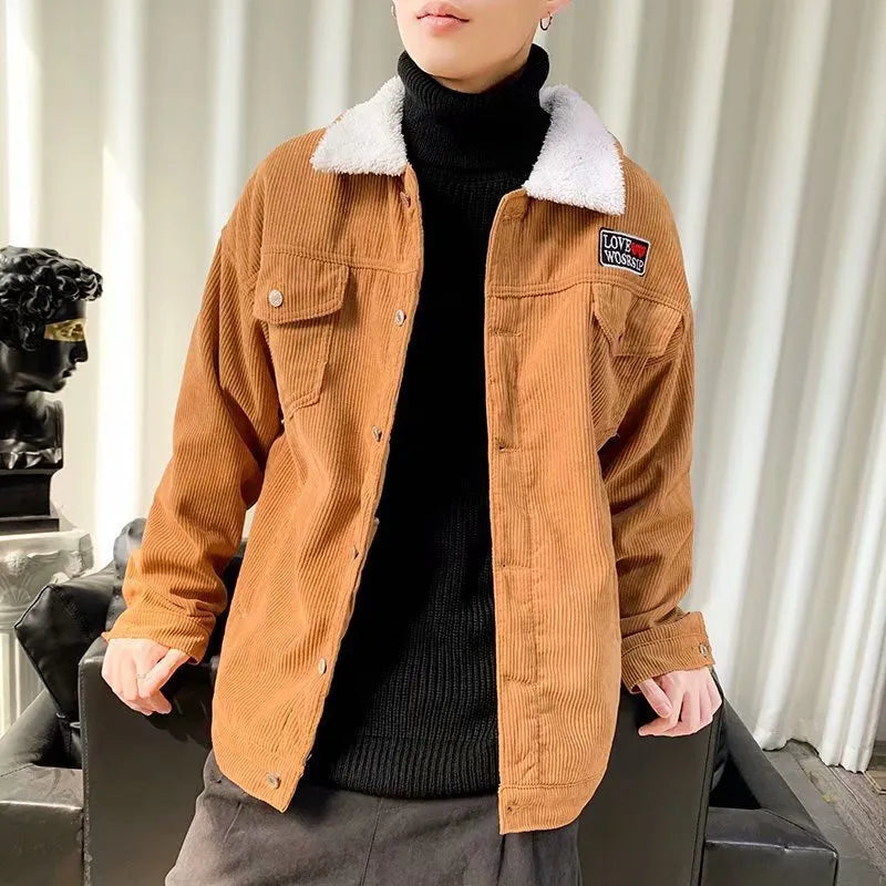 Man wearing a khaki loose-fit corduroy workwear jacket with side pockets.