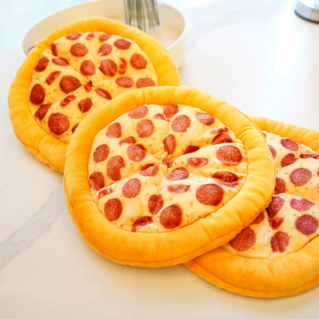 Yellow pizza slice shaped squeaky dog chewing toy with textured toppings and crust detailing