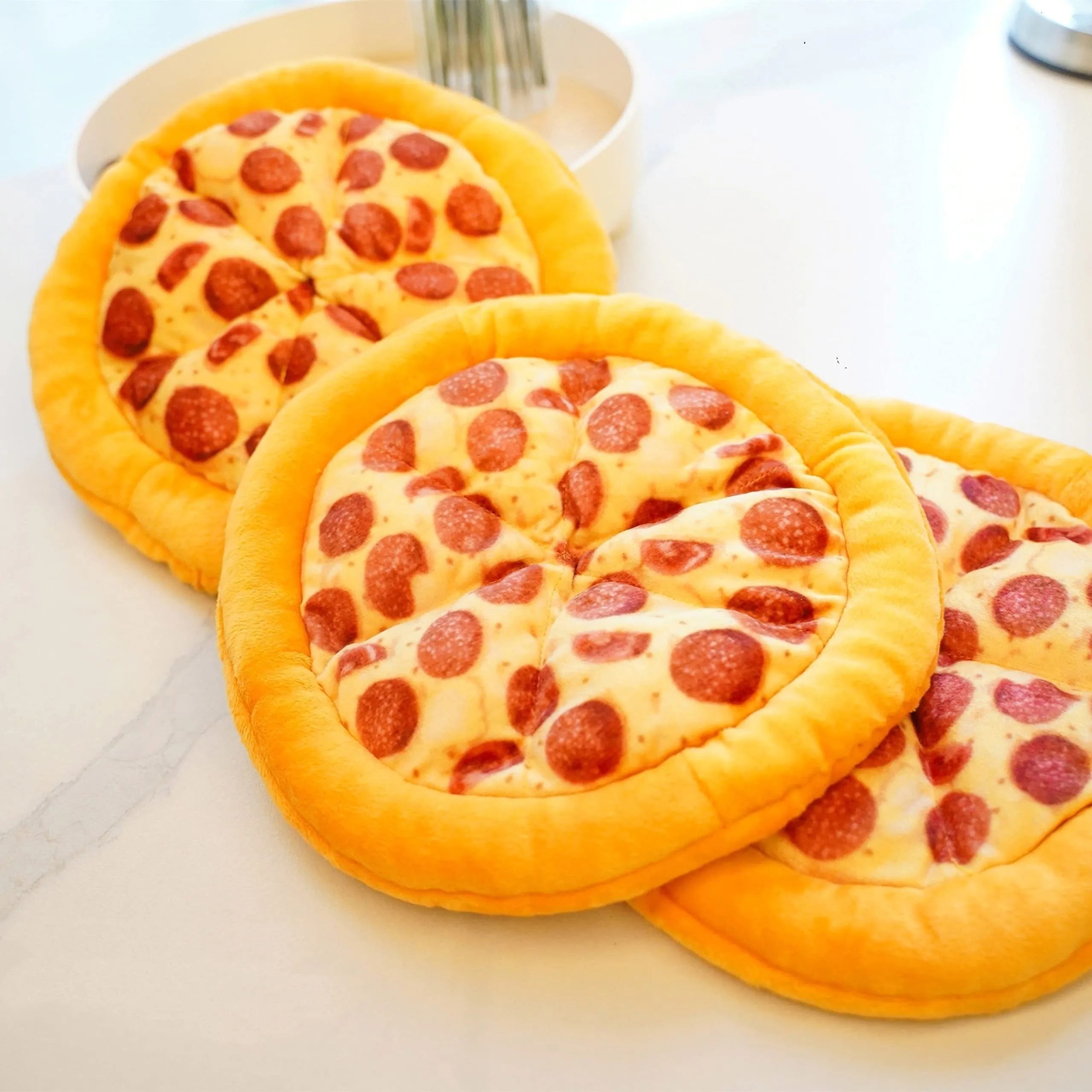 Yellow pizza slice shaped squeaky dog chewing toy with textured toppings and crust detailing