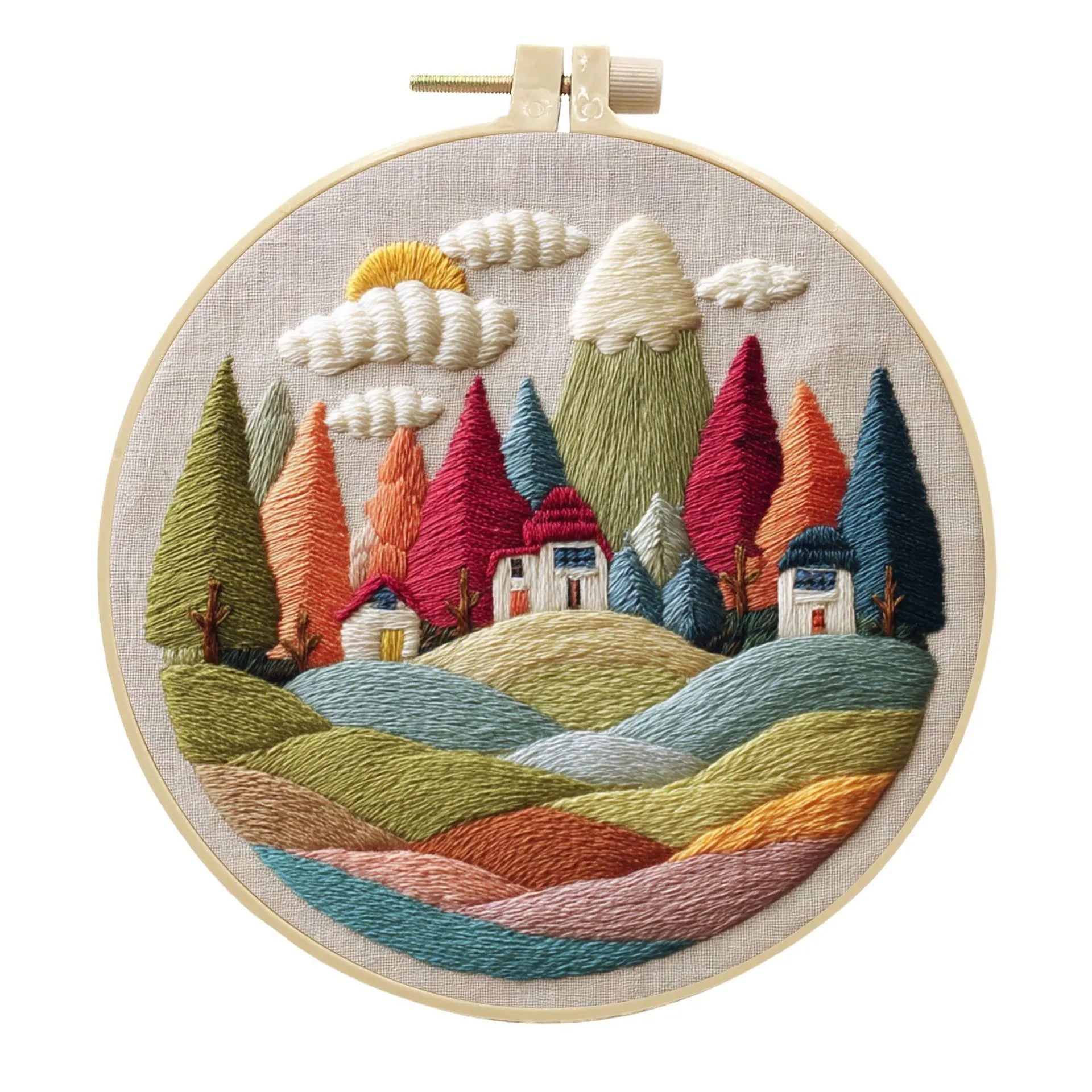 DIY landscape embroidery kit with cotton fabric, bamboo frame, threads and needles arranged for crafting