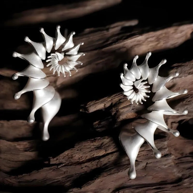 A pair of conch-shaped stud earrings with a three-dimensional matte finish in an irregular simple style.