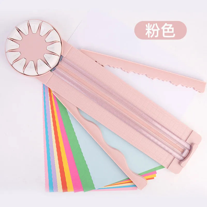 Pink and black plastic paper cutting machine with 12 patterns on desktop