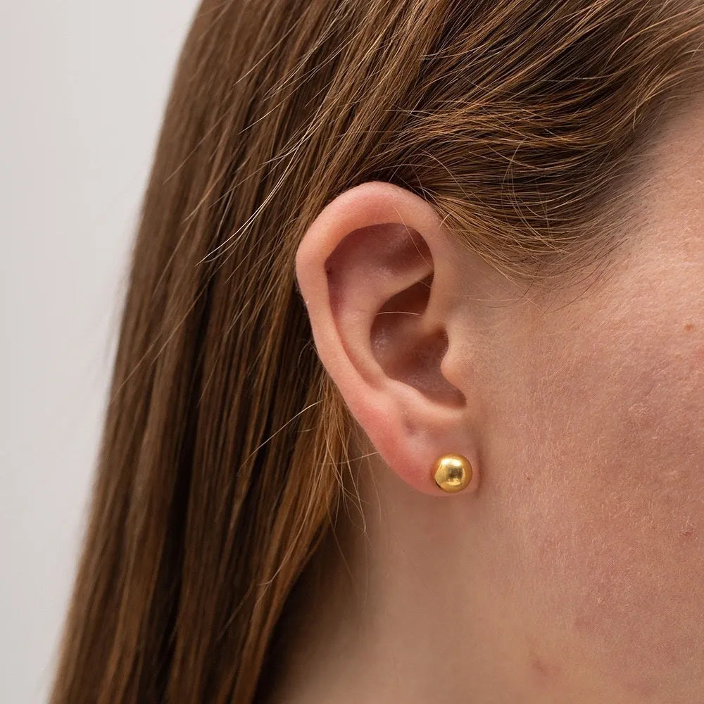 Stainless steel ball stud earrings in gold and silver colours with geometric round design