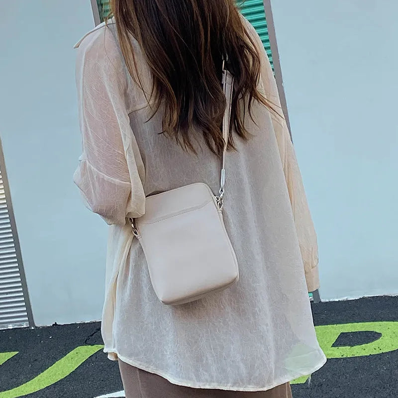Small solid colour mobile phone crossbody bag in PU leather measuring 14.5cm wide