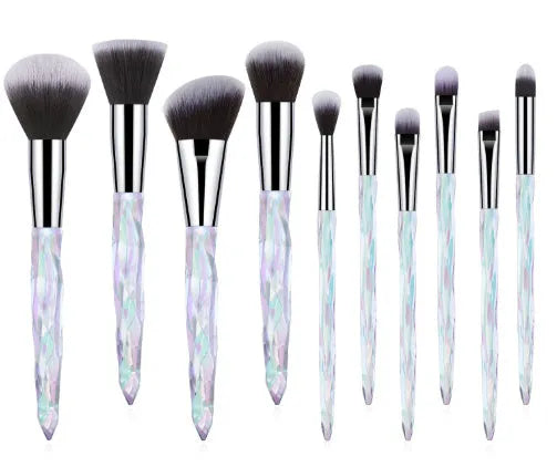 Ten crystal-handle foundation makeup brushes with synthetic bristles laid out flat