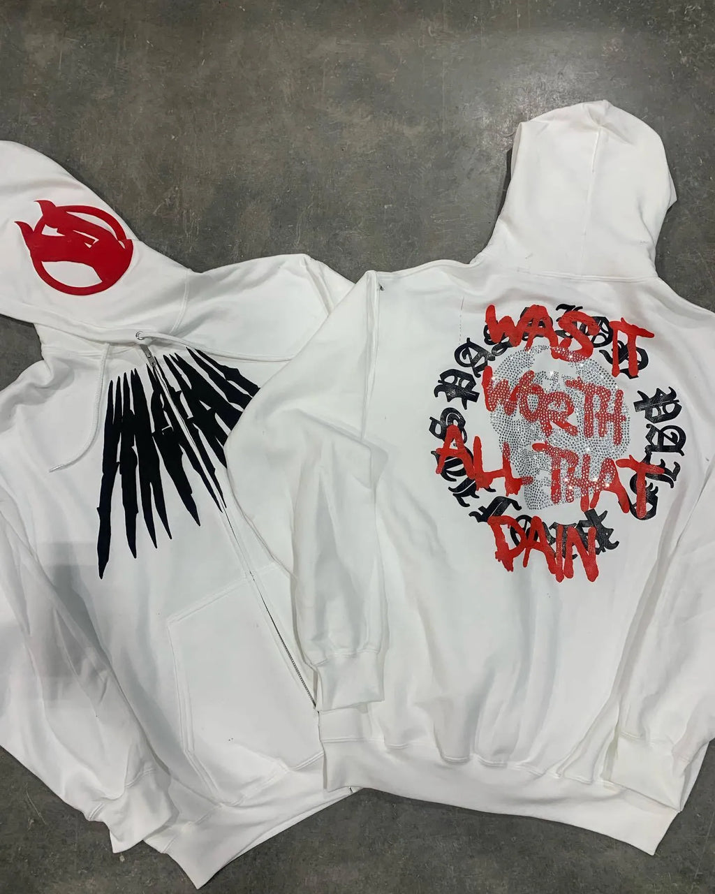 Black hooded sweatshirt with printed white skull pattern and rhinestone details, loose cardigan style