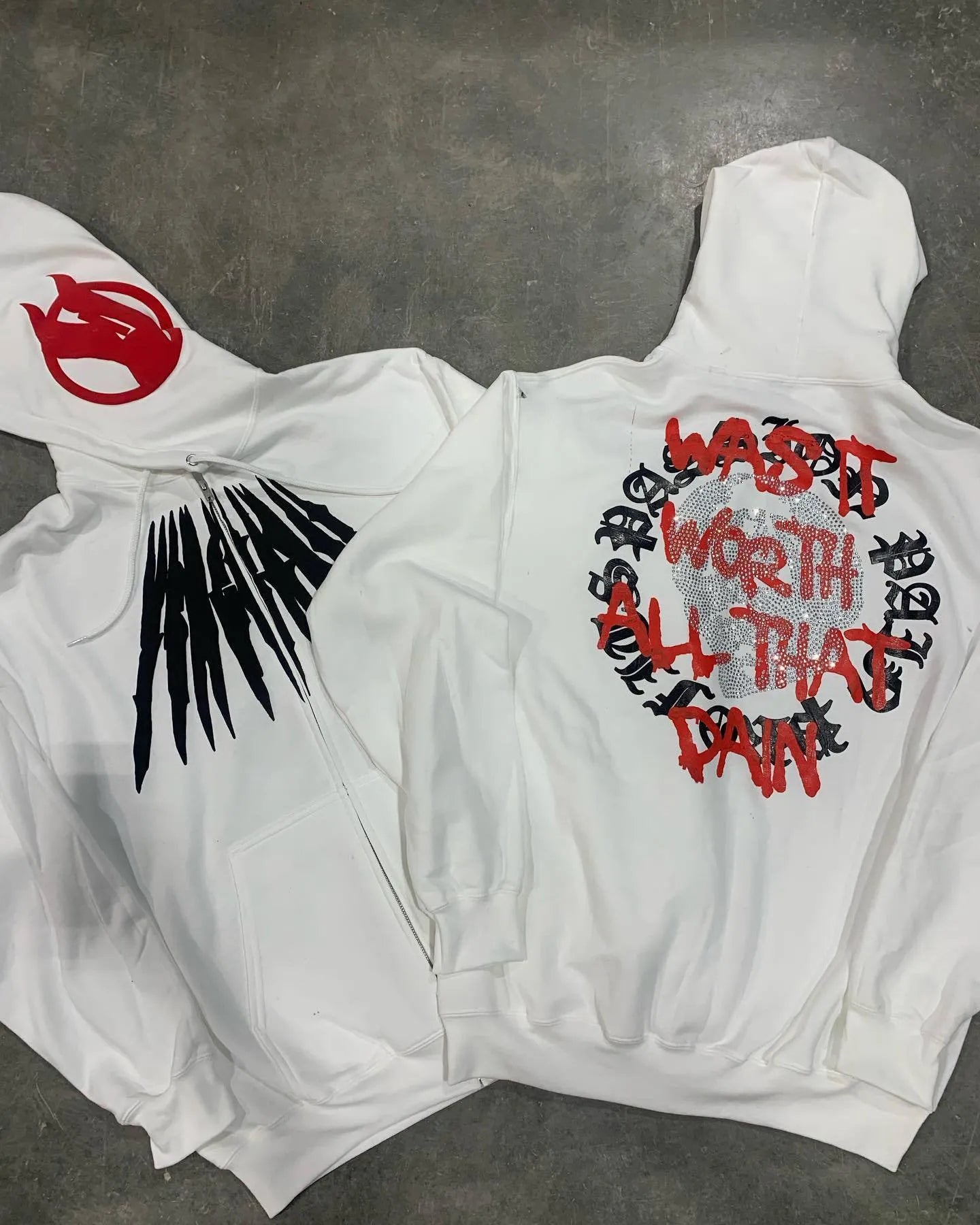 Black hooded sweatshirt with printed white skull pattern and rhinestone details, loose cardigan style