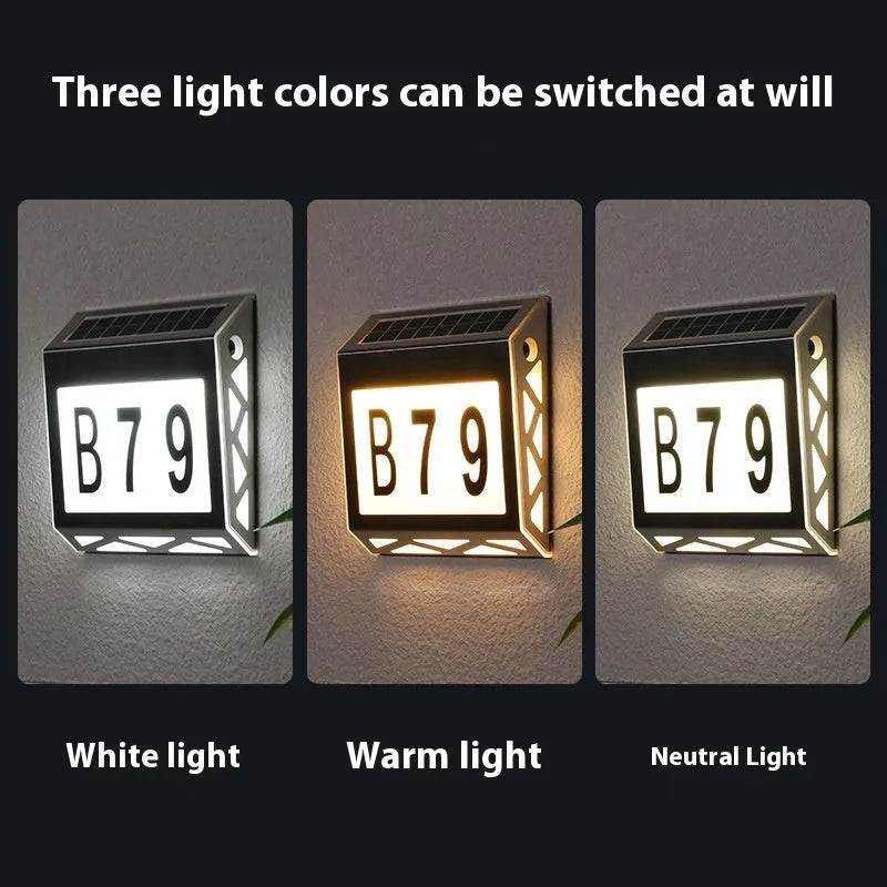Black solar-powered doorplate light with LED illumination for house numbers measuring 180x50x200mm
