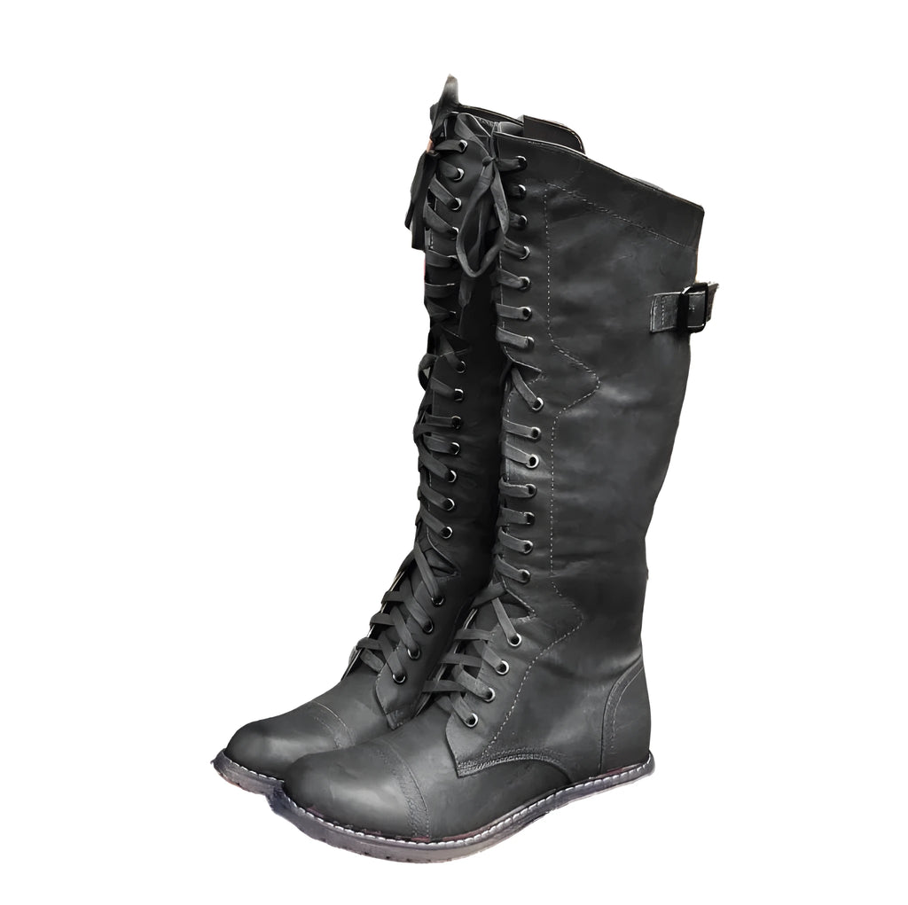 Women's black knight ankle boots with a cross strap design over the instep.