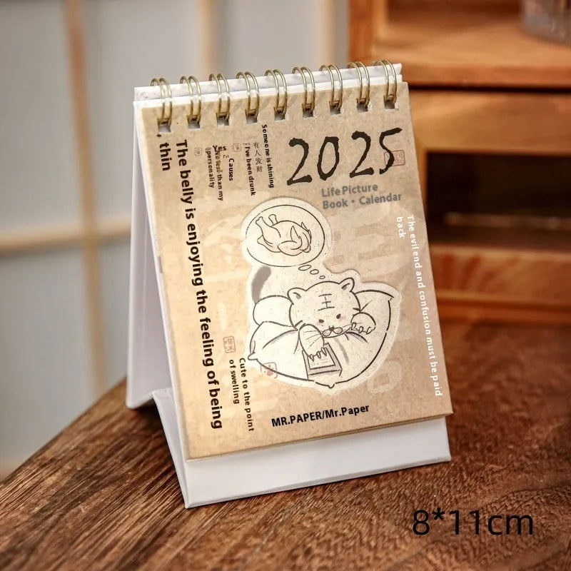 Mini 2025 desk calendar in a simple modern design on a wooden desk