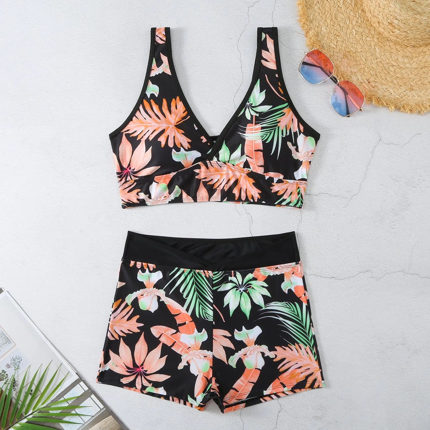 Women's two-piece swimsuit set with sleeveless top and printed boxer-style bottoms in a multi-colour pattern.