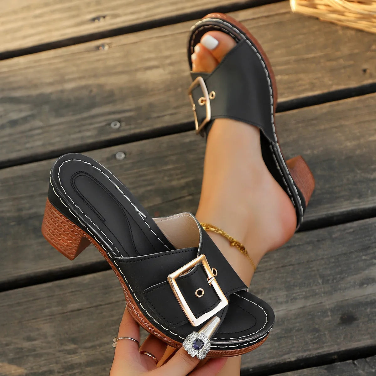 Women's black retro style slippers with a chunky heel and silver metal buckle on a rubber sole.