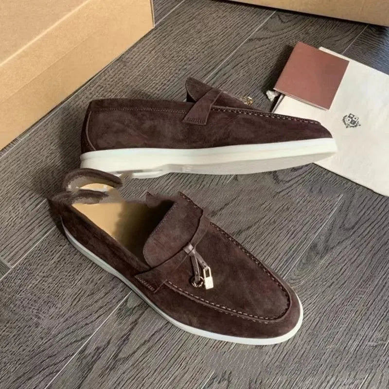 Unisex high-top slip-on loafers with a round toe cap and rubber sole on a neutral background.