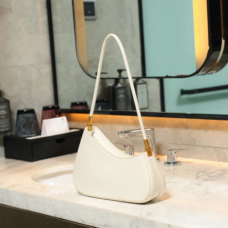 Women's retro oval PU leather shoulder bag in seven colour options with single strap and internal zipper compartment