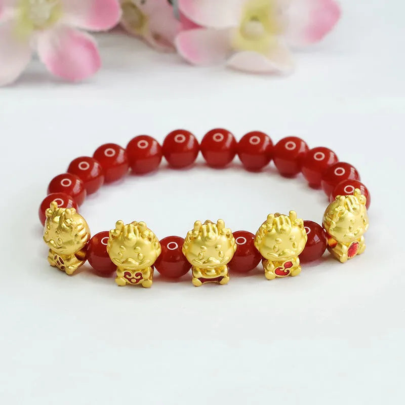 Close-up of 8mm red agate bracelet with carved Five Blessings Dragon design on wrist.