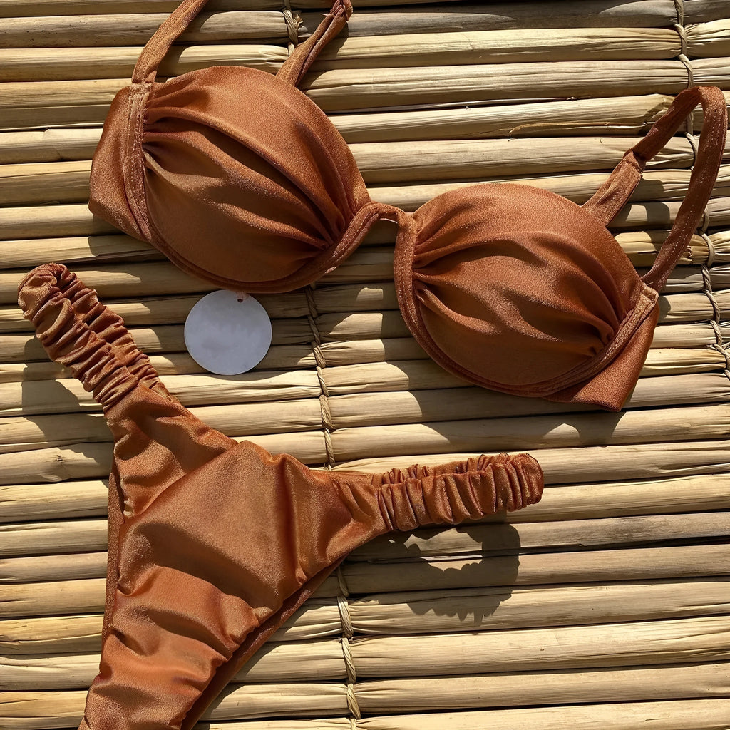 Women's black underwire bikini swimsuit set with split briefs on a neutral background.