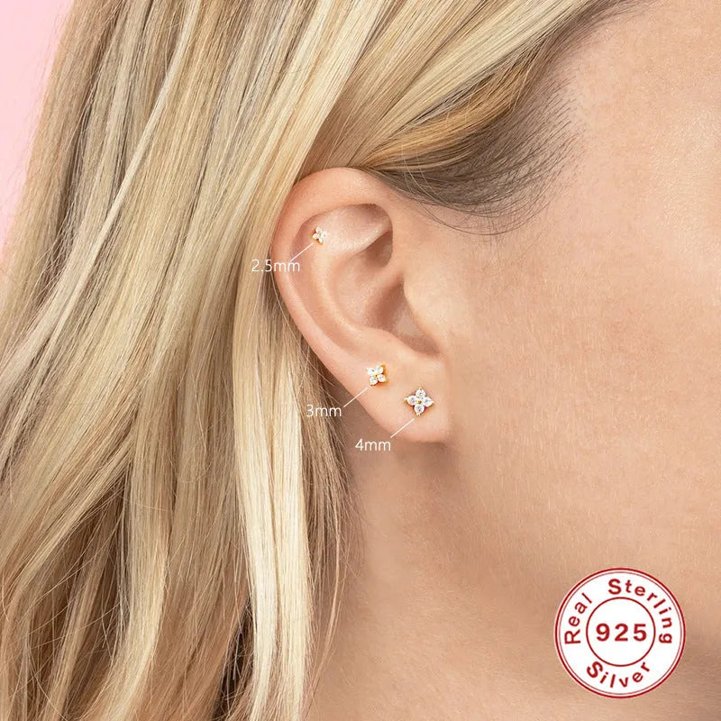 S925 sterling silver stud earrings with small crystal flower petals in gold and platinum finishes.
