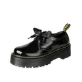 Women's black thick soled lace-up shoes with ribbon detail on a white background