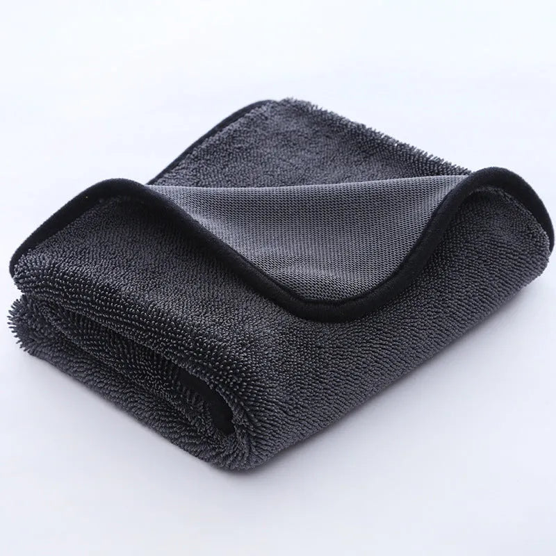 Grey car cleaning towel with red edge trim showing braid twisted texture for automotive glass washing