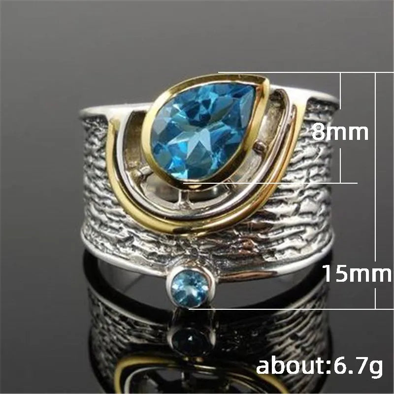 Close-up of a women's blue zircon alloy ring with Chinese style drop shape design and rhinestone inlay.