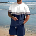 Man wearing a loose light blue short-sleeved T-shirt and matching shorts from a summer leisure suit set.