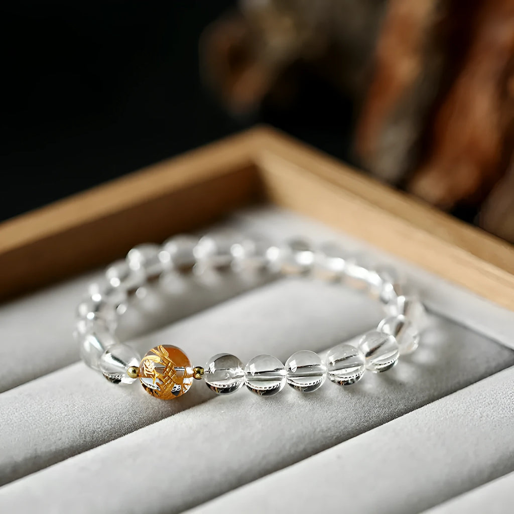 Geometric unisex bracelet with black obsidian agate beads, white crystal beads, and a golden dragon crystal focal bead.